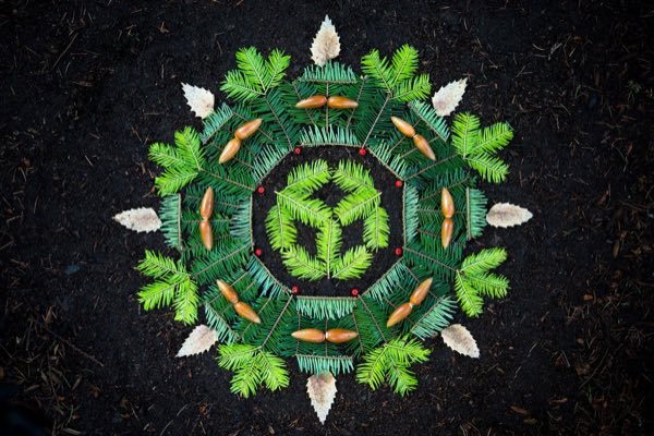 Altar made from green fern fronds, acorns, and dried leaves